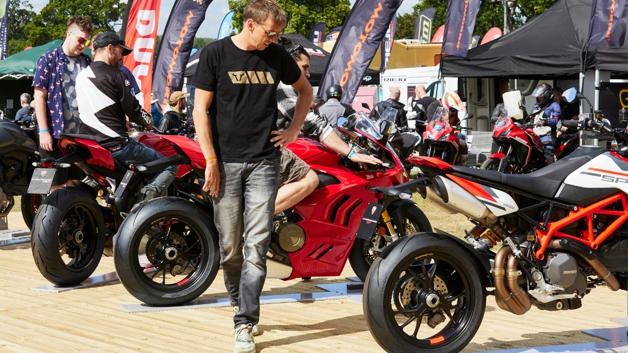 4 An Adventure Bike Rider Festival visitor looking at Ducati motorbikes