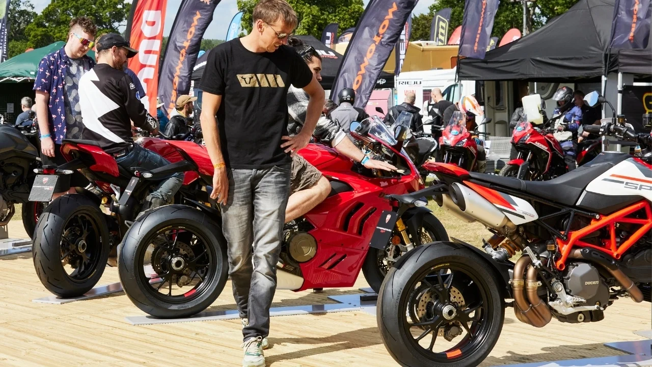 An Adventure Bike Rider Festival visitor looking at Ducati motorbikes