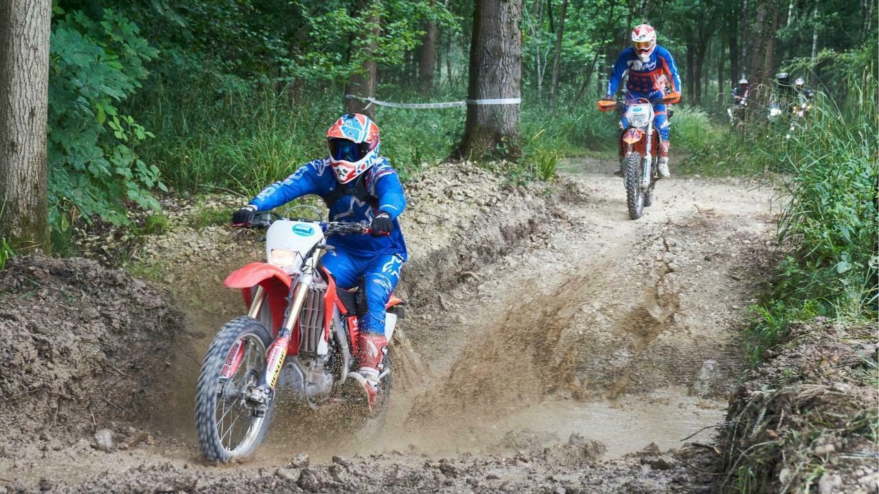 5 A pair of motorcyclists riding through a water crossing on the adventure trail at the Adventure Biker Rider festival.