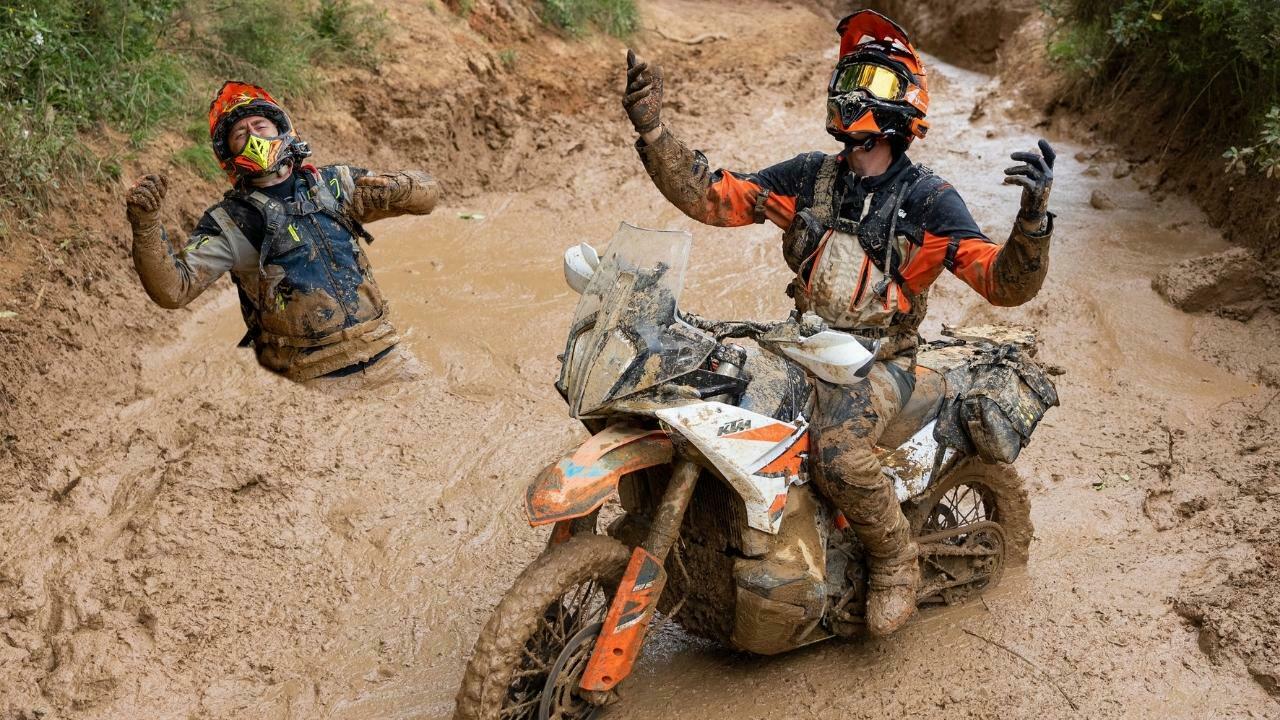 4 Two motorcycle riders stuck in the mud on their KTM adventure motorcycles