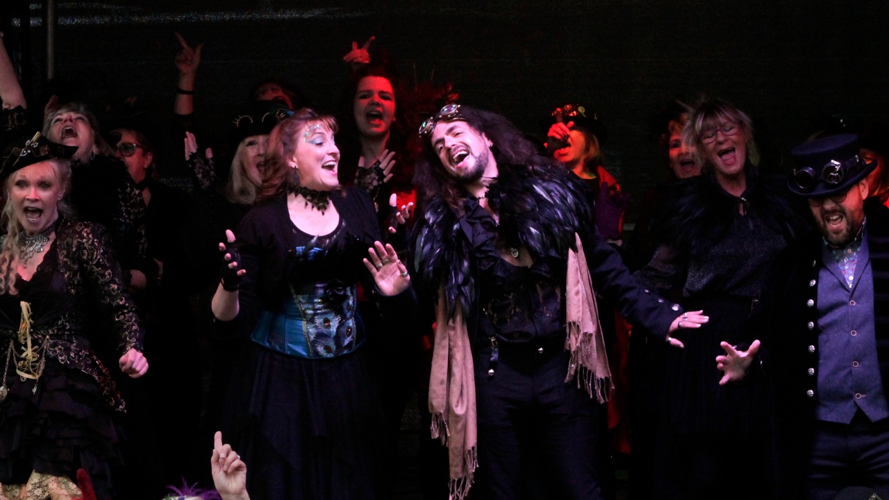 Voices Unlimited singers in gothic costumes performing