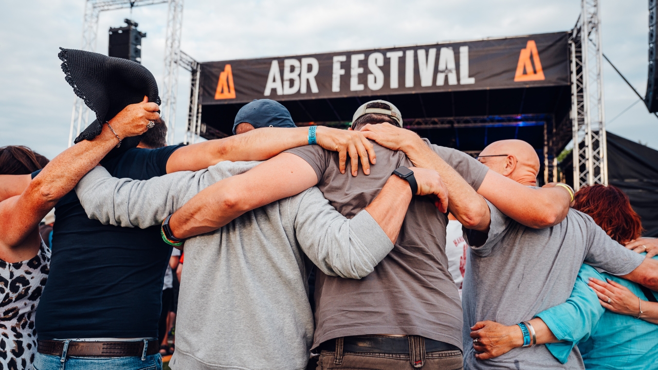 A group of motorcyclists dancing in front of the ABR Festival main stage