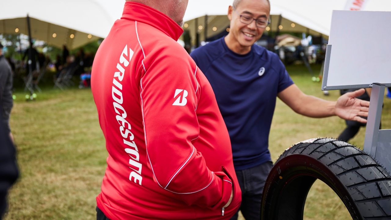 Colleague from Bridgestone helping a customer at the ABR Festival 2023 with tyres
