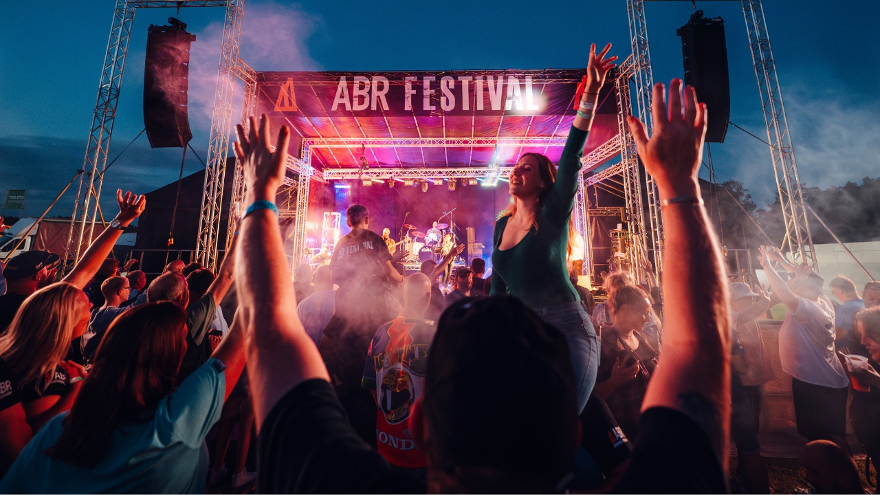 A crowd of bikers having a great time in front of the main music stage at the ABR Festival